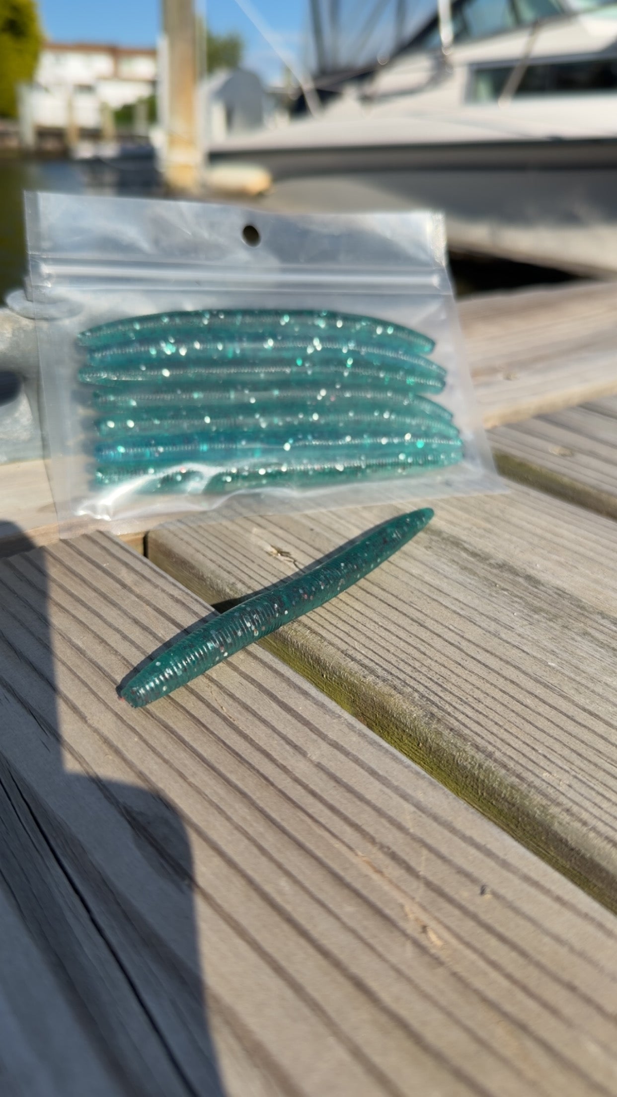 Bait Bros Tackle 5-inch stick bait fishing lure with bright coloration and flexible design for freshwater or saltwater fishing.